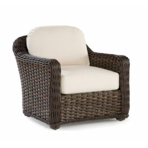 Wicker armchair with beige cushions, perfect for indoor or outdoor use.