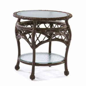 Antique round wooden side table with intricate carved legs and two glass shelves.
