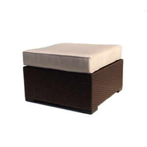 Wicker ottoman with beige cushion on top.