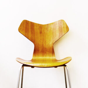 Modern wooden chair with a sleek, curved design and metal legs.