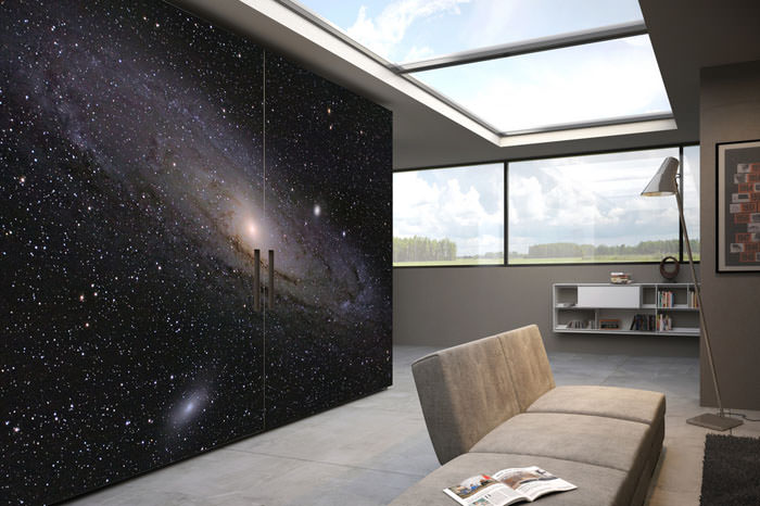 Modern room with a cosmic galaxy wall mural and large skylight.