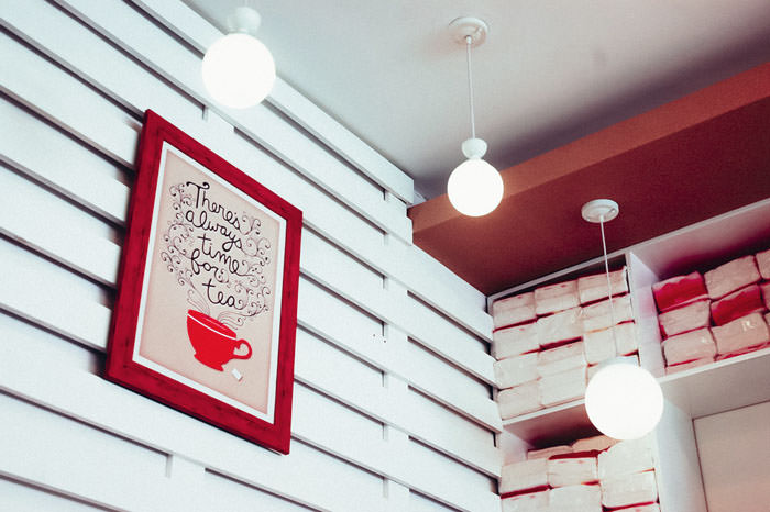 Modern café interior with white walls and hanging lights.