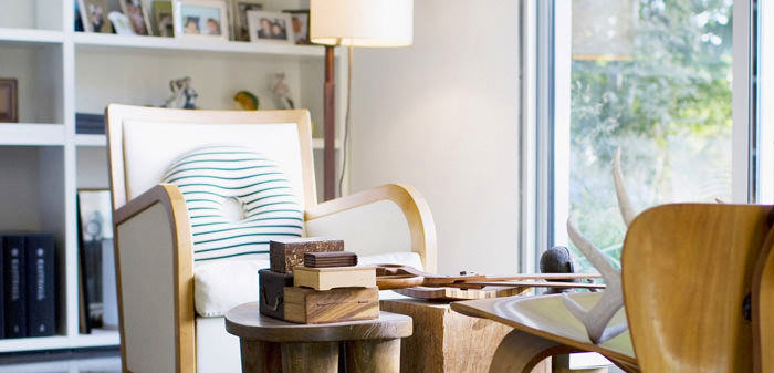 Cozy living room with wooden furniture and soft cushions.