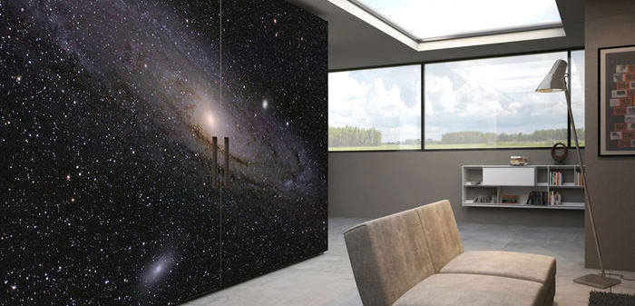 Modern dining room with a galaxy-themed wall mural and large windows.