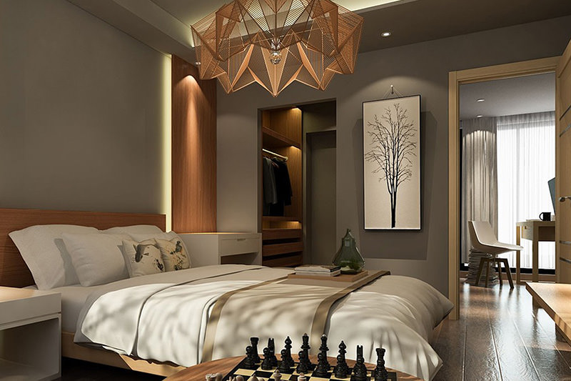 Cozy bedroom with artistic decor and warm lighting.