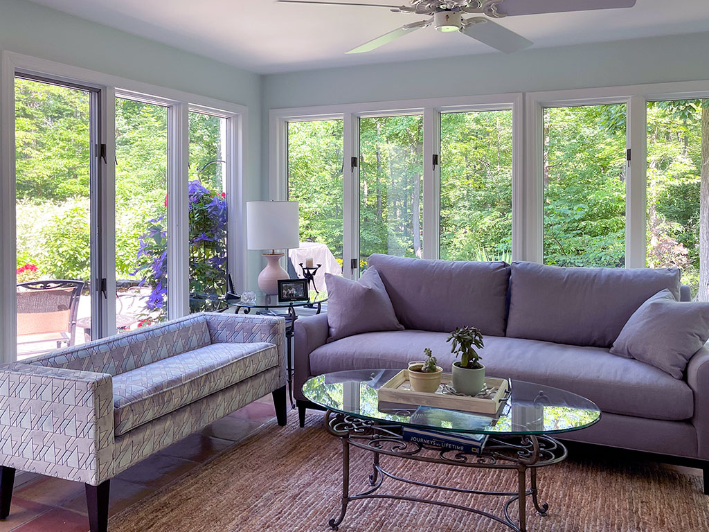 Bright living room with large windows and elegant furniture.