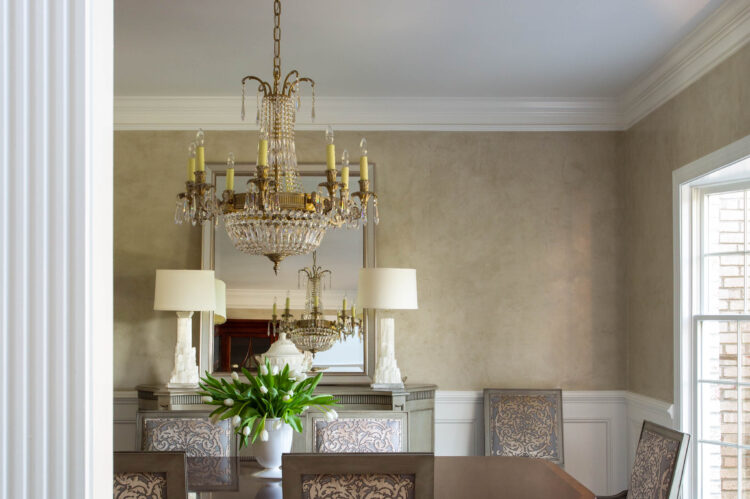 Elegant dining room with wooden table and chandelier.